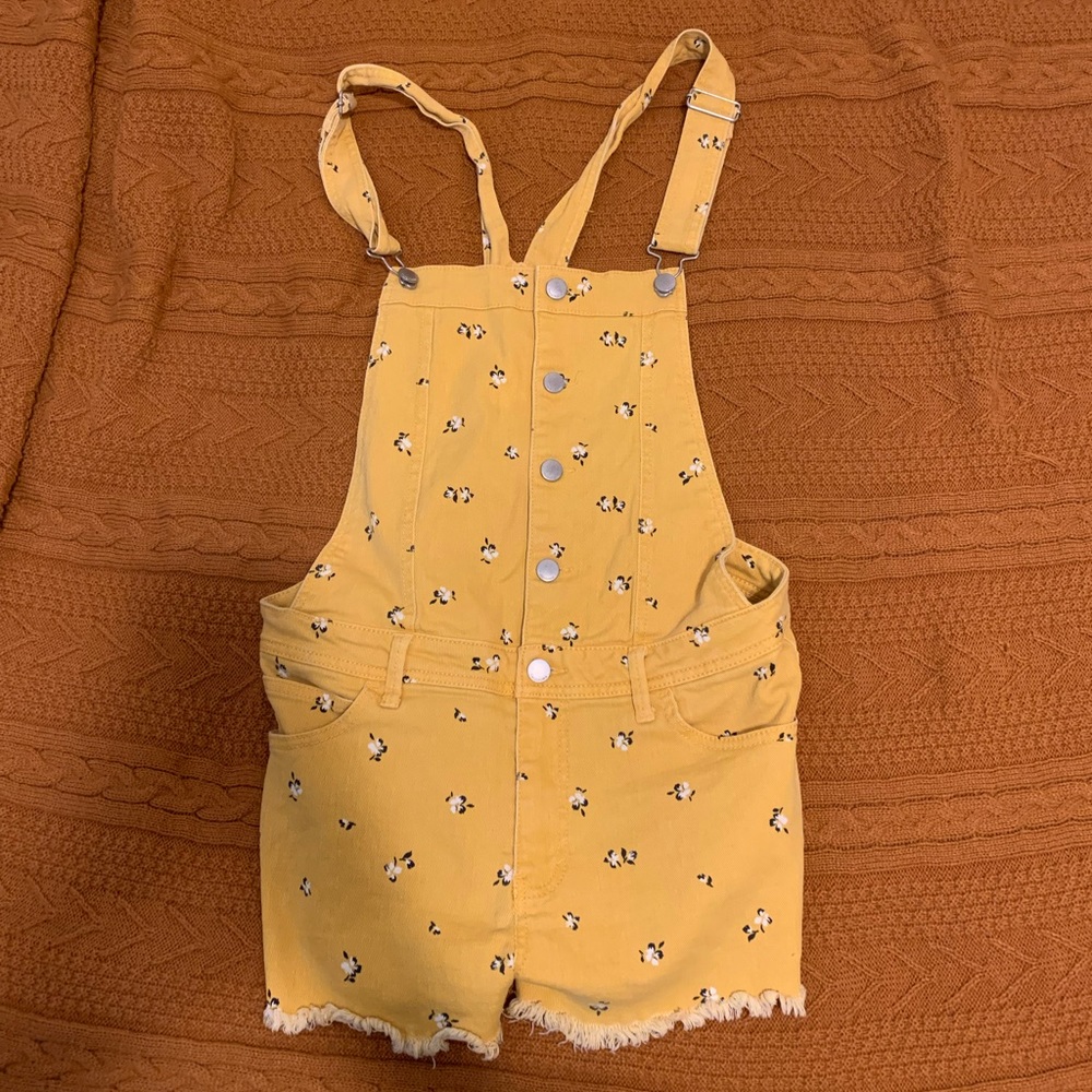 yellow overalls with white flowers